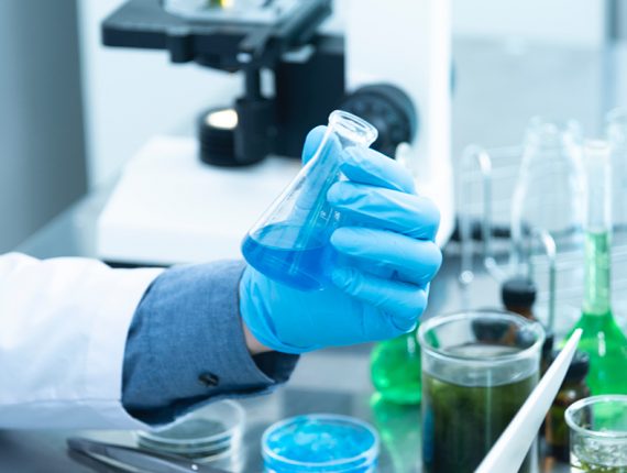 hand holding blue liquid in test tube